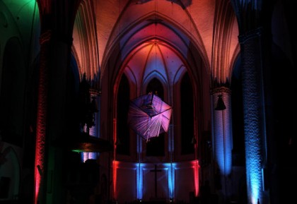 Gisela Meyer-Hahn “Cube as Gliding Silence in Space” Textile installation for concert during which space, light, and color interact with musicians at St. Peter’s Church in Hamburg Germany 2010. Photo: Hans Hermann Schramm.